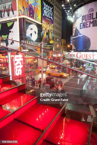 view of time square at night. - red grant stock-fotos und bilder