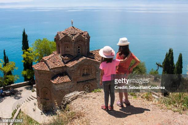moment of encouragement, for two sisters, for sight sveti (saint) jovan kaneo church on lake ohrid, macedonia - macedonian orthodox church stock pictures, royalty-free photos & images