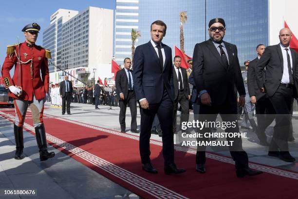 French President Emmanuel Macron and Moroccan King Mohammed VI arrive to inaugurate a high-speed line at Tangiers train station on November 15, 2018....