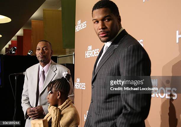 Hero Honoree Wesley Autrey, daughter Shuqui Wesley and NFL player Michael Strahan pose in the press room during "CNN Heroes: An All-Star Tribute"...