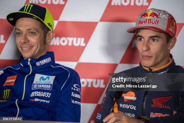 Valentino Rossi of Italy and Movistar Yamaha MotoGP smiles and Marc Marquez of Spain and Repsol Honda Team looks on during the press conference...