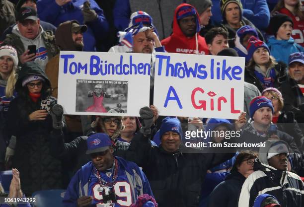 Buffalo Bills fans hold up signs that mock Tom Brady of the New England Patriots with comparisons to his wife Gisele Bundchen during NFL game action...