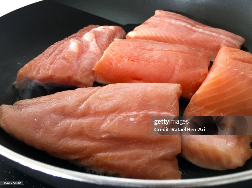 Raw Salmon Fish Fillets  on a Frying Pan