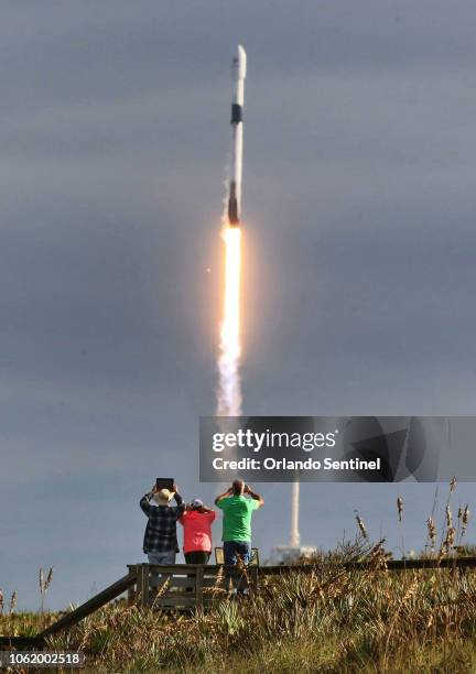 SpaceX fans watch the Falcon 9 lift-off from pad 39-A in this view from Playalinda Beach, Fla., just north of Kennedy Space Center, Thursday, Nov....