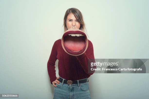 woman using a megaphone - promoter stock-fotos und bilder