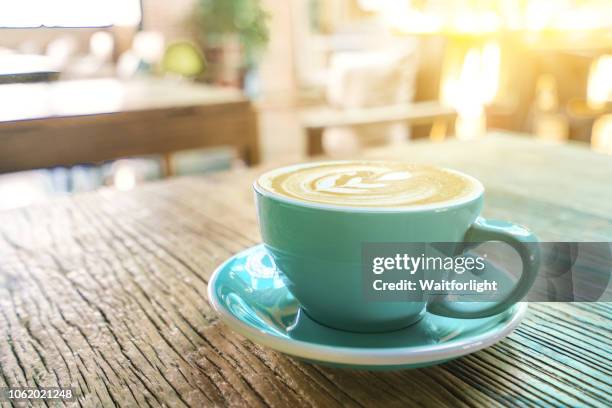 a cup of coffee on table - coffee cups table stockfoto's en -beelden