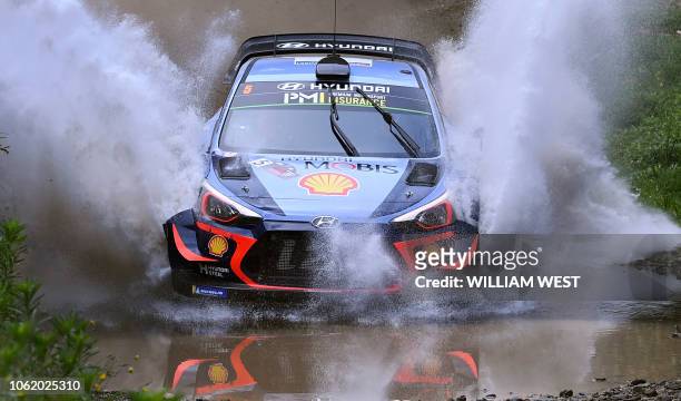 Hyundai driver Thierry Neuville of Belgium speeds through a creek on the first day of the World Rally Championship Rally Australia near Coffs Harbour...