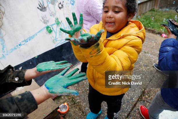 young boy with wet green paint on hands high angle - paint handprint stock pictures, royalty-free photos & images