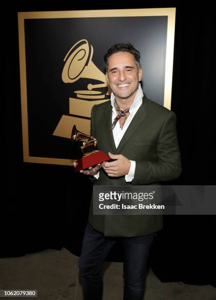 Jorge Drexler poses with the Best Singer-Songwriter Album award backstage at the Premiere Ceremony during the 19th Annual Latin GRAMMY Awards at MGM...