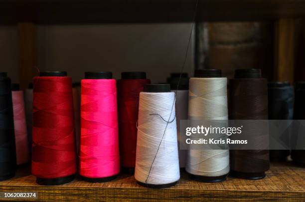 several colorful line reels, on shelf of fixtures - rayon spool stock pictures, royalty-free photos & images