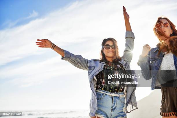 there's nothing stopping you from being you - lens flare young people dancing on beach stock pictures, royalty-free photos & images