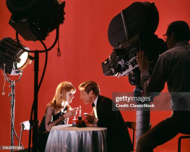 1970s 1980s COUPLE ACTING OUT DATE AT RESTAURANT ON MOVIE STUDIO SET BEING FILMED FOR TELEVISION COMMERCIAL