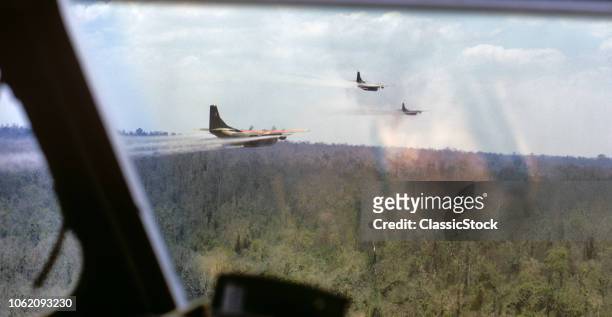 1960s MARCH 1969 OPERATION RANCH HAND USAF UC-123B PROWLER AIRCRAFT SPRAYING AGENT ORANGE DEFOLIANT SOUTH VIETNAM