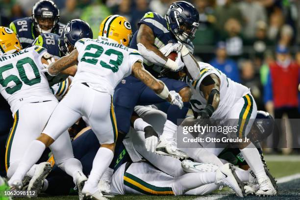 Chris Carson of the Seattle Seahawks scores a touchdown in the second quarter against the Green Bay Packers at CenturyLink Field on November 15, 2018...