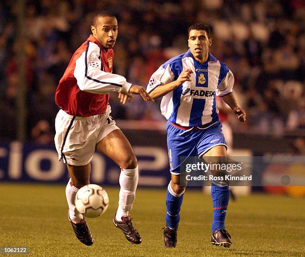 Thierry Henry of Arsenal breaks away from Norredine Naybet of Deportivo during the UEFA Champions League Group D Stage Two match between Deportivo La...