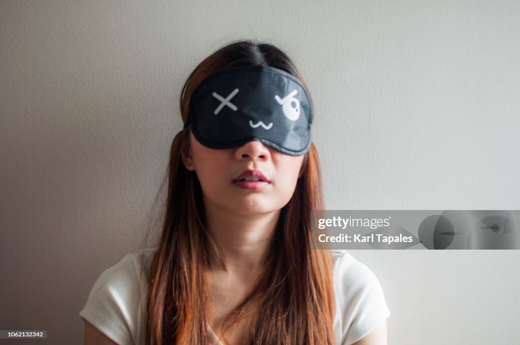 A portrait of a woman with sleeping mask