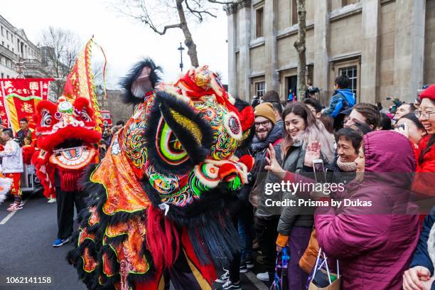England, London, Chinese New Year Parade, Child Wearing Chinese Lion Mask