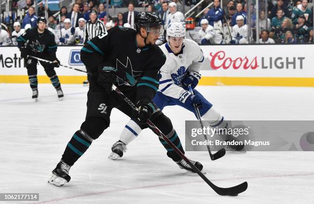 Evander Kane of the San Jose Sharks skates with the puck against Mitchell Marner of the Toronto Maple Leafs at SAP Center on November 15, 2018 in San...