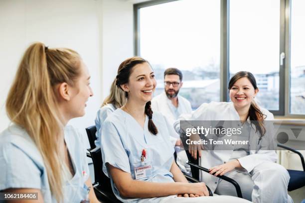 medical students laughing during seminar - a celebration of arts education stockfoto's en -beelden