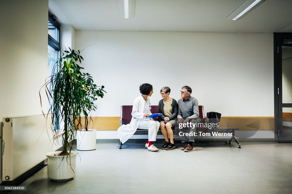 Doctor Talking To Elderly Couple