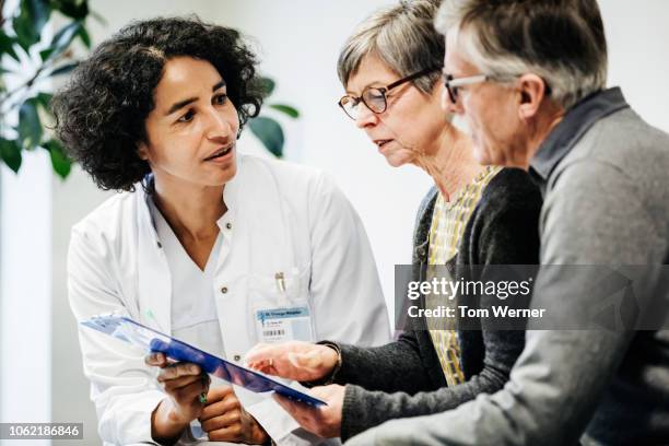 clinical doctor giving test results to patients - see no evil hear no evil speak no evil fotografías e imágenes de stock