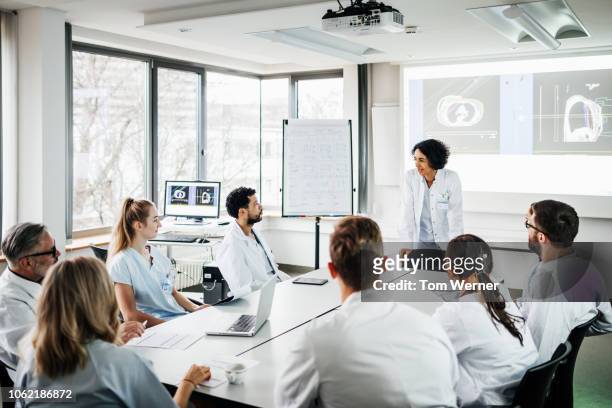group of doctors listening to presentation - germany team presentation stockfoto's en -beelden