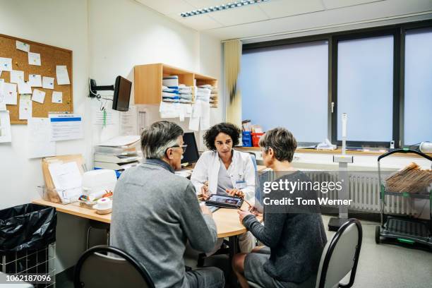 clinical doctor talking to patients - general practitioner ストックフォトと画像