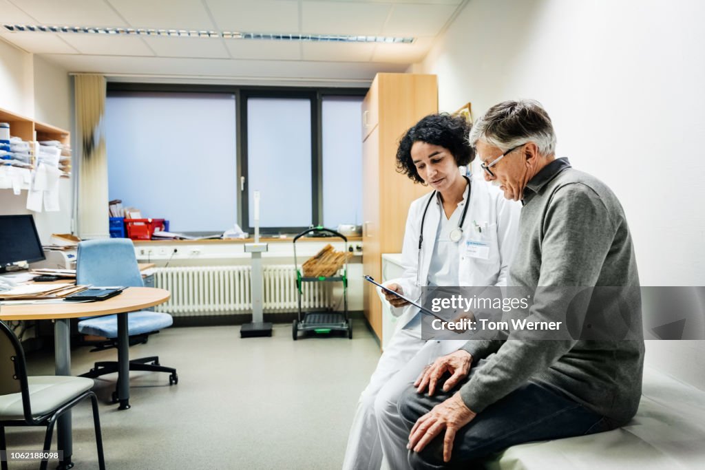 Elderly Man Talking To Doctor About Test Results