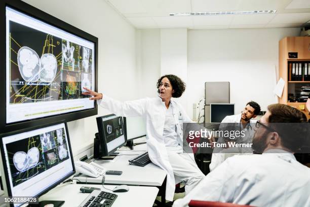 registrar reviewing patient's test results with doctors - group people thinking stock pictures, royalty-free photos & images