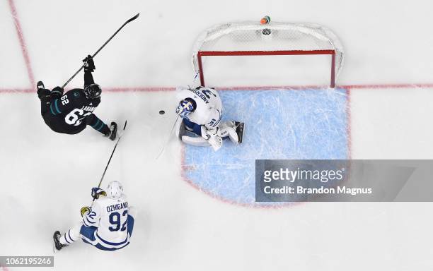 An overhead view as Kevin LaBanc of the San Jose Sharks drives to the net on Igor Ozhiganov and Frederik Anderson of the Toronto Maple Leafs at SAP...