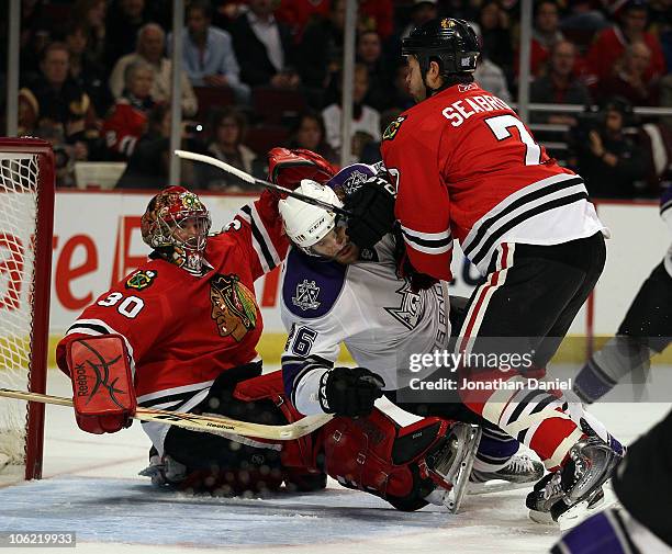 Brent Seabrook of the Chicago Blackhawks knocks down Michal Handzus of the Los Angeles Kings in front of Marty Turco at the United Center on October...