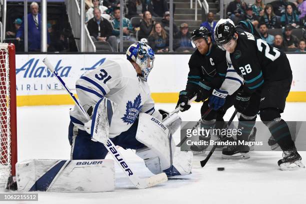 Timo Meier and Joe Pavelski of the San Jose Sharks drive the net on Frederik Andersen of the Toronto Maple Leafs at SAP Center on November 15, 2018...