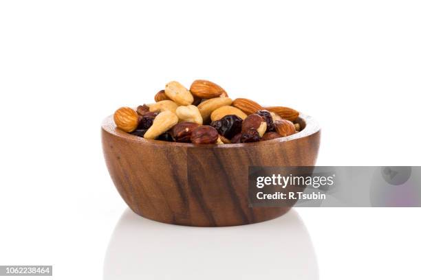 mix nuts, dry fruits and raisin on a white background - snack bowl stock pictures, royalty-free photos & images