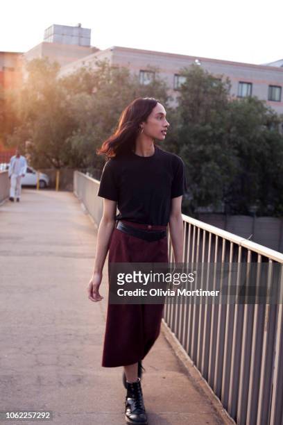 Woman walking over a bridge in the city