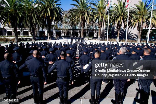 Santa Ana Police officers listen to Chief of Police David Valentin during an inspection at their headquarters in Santa Ana, CA on Thursday, November...