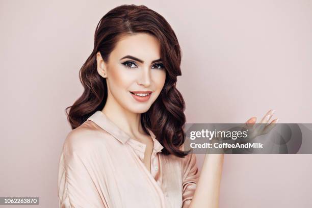 woman with voluminous curly hairstyle - perm hair style stock pictures, royalty-free photos & images