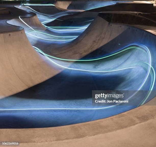 illuminated skatepark / skateboarder light painting - light painting stock pictures, royalty-free photos & images
