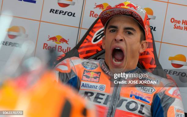 Repsol Honda Team's Spanish rider Marc Marquez yawns in the paddock during the first free practice session of the MotoGP Valencia Grand Prix at the...