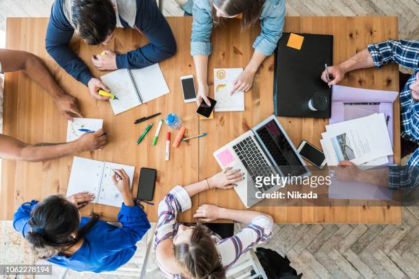 young business team working together at office - new business stock pictures, royalty-free photos & images
