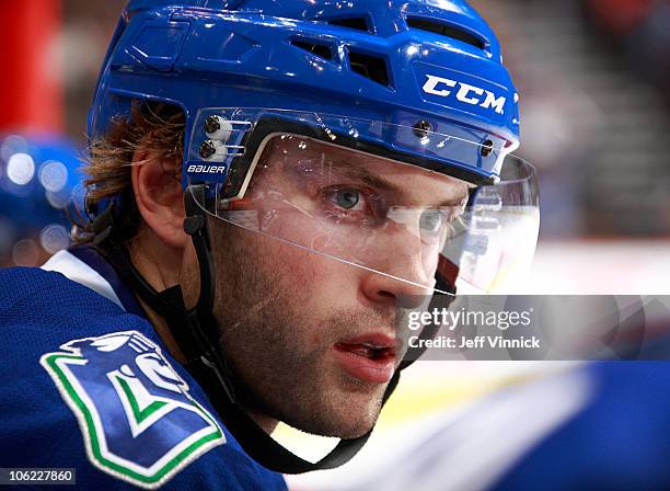 Ryan Parent of the Vancouver Canucks looks on from the bench during a game against the Minnesota Wild at Rogers Arena on October 22, 2010 in...