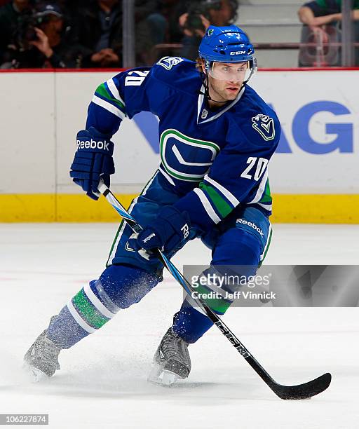 Ryan Parent of the Vancouver Canucks skates up ice with the puck during a game against the Minnesota Wild at Rogers Arena on October 22, 2010 in...
