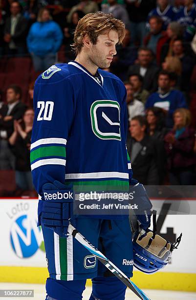 Ryan Parent of the Vancouver Canucks listens to the national anthem during a game against the Minnesota Wild at Rogers Arena on October 22, 2010 in...