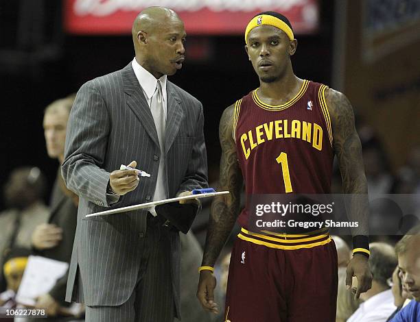 Head coach Byron Scott of the Cleveland Cavaliers talks over a play with Daniel Gibson while playing the Boston Celtics at Quicken Loans Arena on...