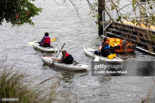 trio of kayakers on river - kayaking australia stock pictures, royalty-free photos & images