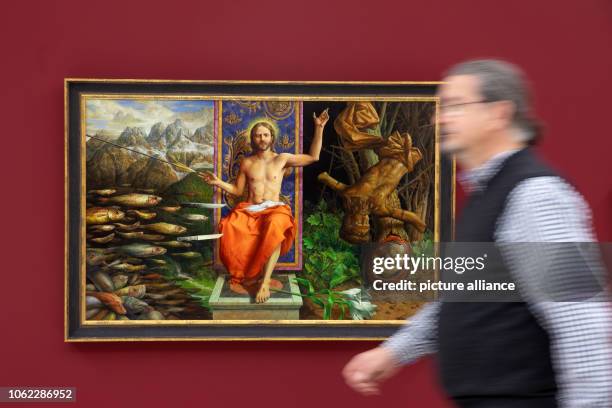 November 2018, Thuringia, Erfurt: A man runs alongside the painting "Around Midnight" in the exhibition of the Leipzig painter Michael Triegel in the...