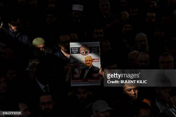 Person holds a banner of Jamal Khashoggi during a symbolic funeral prayer for the Saudi journalist, killed and dismembered in the Saudi consulate in...