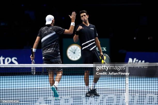 Marcelo Melo of Brazil and Lukasz Kubot of Poland celebrates during their round robin match against Oliver Marach of Austria and Mate Pavic of...