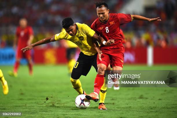 Malaysia's forward Shahrel Fikri Fauzi fights for the ball with Vietnam's defender Nguyen Trong Hoang during the 2018 AFF Suzuki Cup group A football...