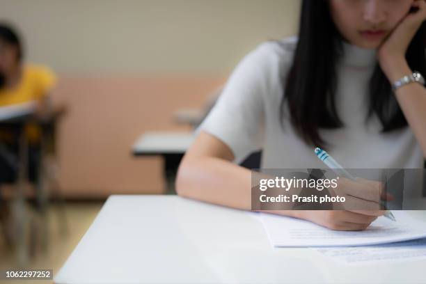 school student's taking exam writing answer in classroom for education and literacy concept - college admission stock pictures, royalty-free photos & images