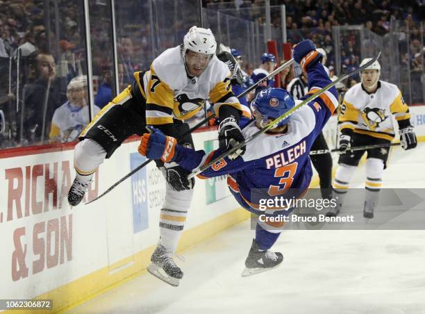 Matt Cullen of the Pittsburgh Penguins checks Adam Pelech of the New York Islanders during the first period at the Barclays Center on November 01,...